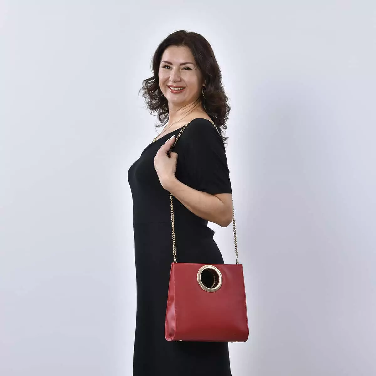Woman posing with Wine Red Faux Leather Fold Over Clutch with Long Chain Strap
